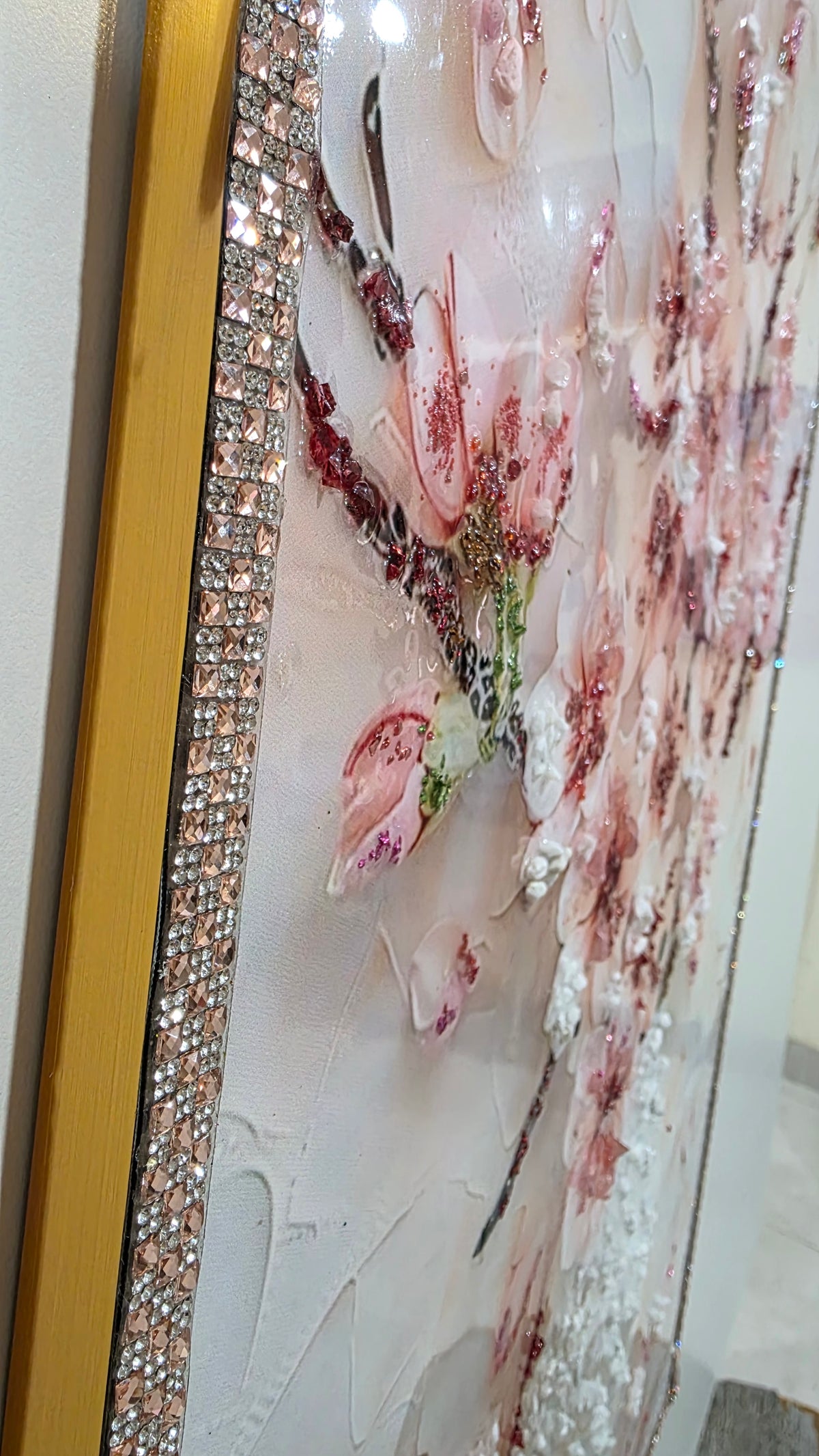 Side view revealing the raised texture extending beyond the artwork surface, with champagne and silver detailing along the edge and an elegant gold outer trim.