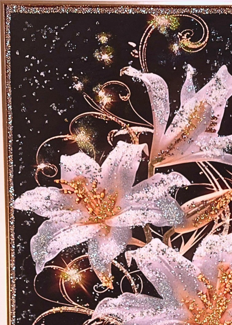 Lilies After Dark shown in its gold wooden frame, featuring three embellished ivory lilies with gold, silver and crystal-like details.