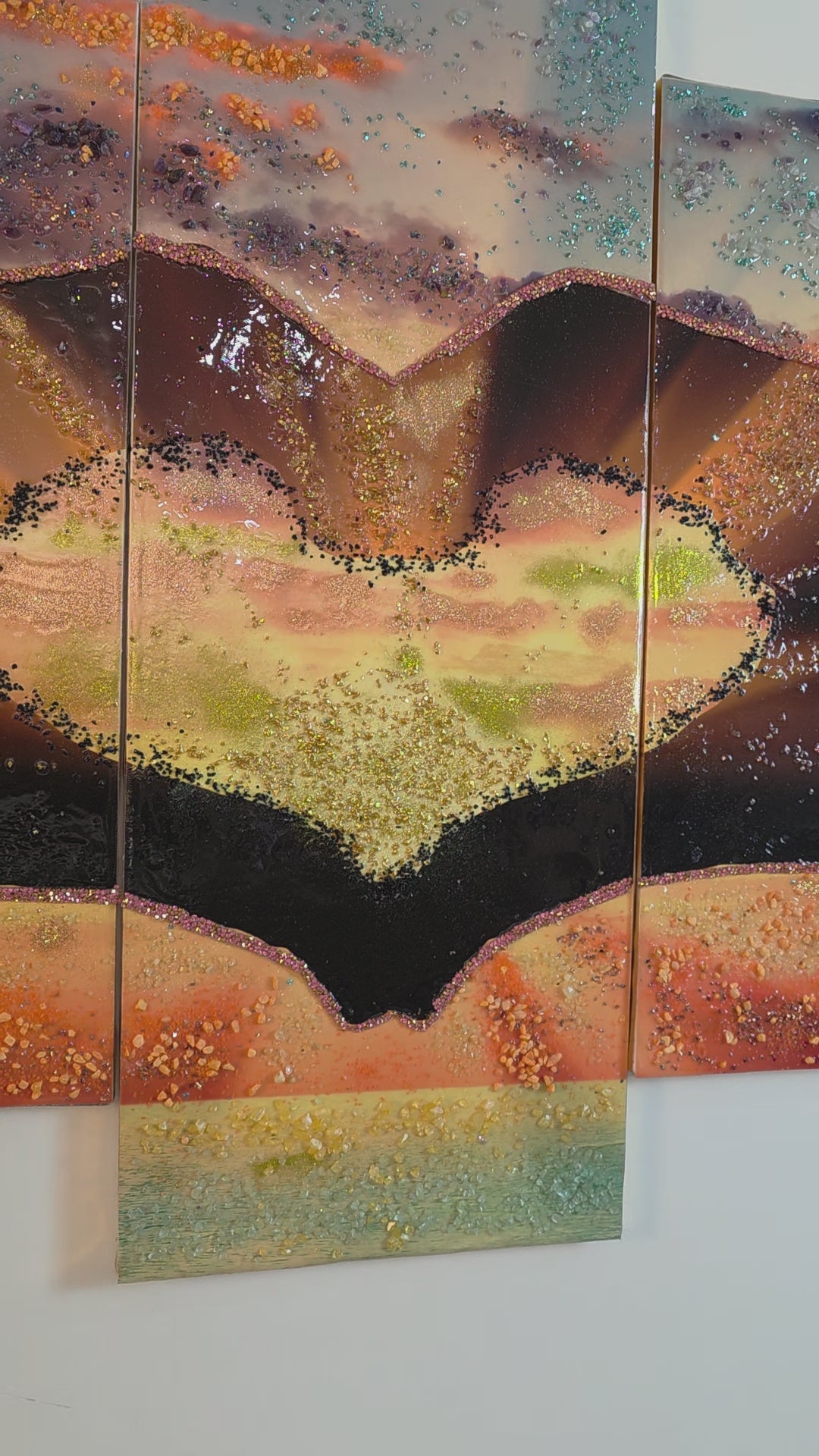 Detail video of the tall centre panel 3 of Sunset in Our Hands in balanced neutral lighting, highlighting the central glowing landscape, resin finish and handcrafted embellishments.