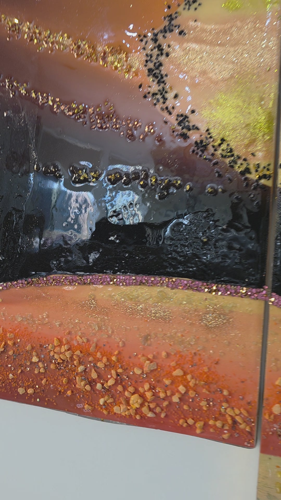 Detail video of panel 2 of Sunset in Our Hands, shown in balanced neutral lighting with its colours, texture and handcrafted embellishments.