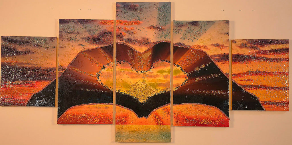 Sunset in Our Hands five-panel wall art shown in warm lighting, highlighting the glowing amber, copper and gold tones and dimensional handcrafted details.